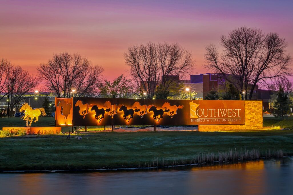 sign of SMSU college at dusk with mustangs lit up