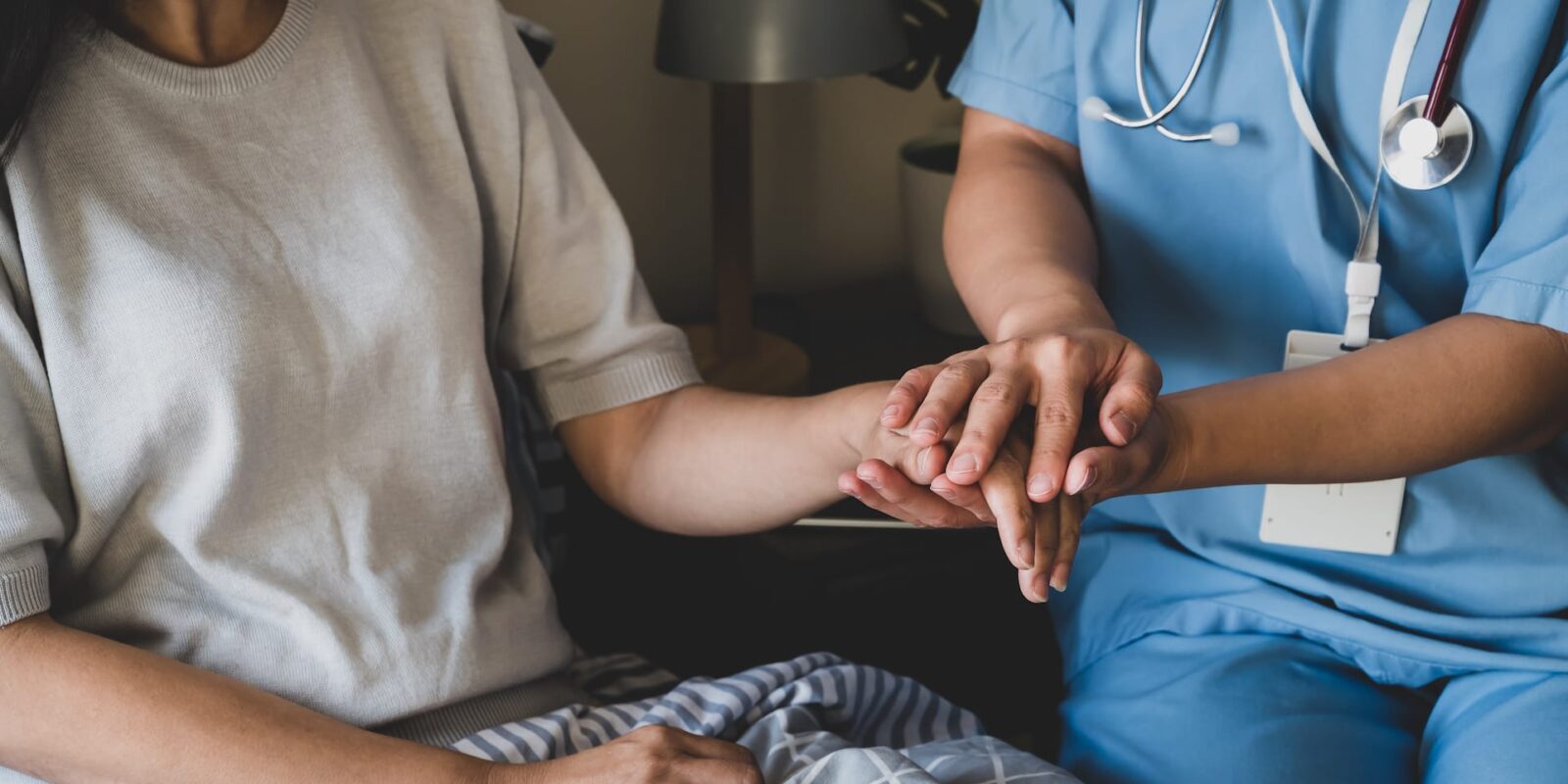 nurse holding a patients hand